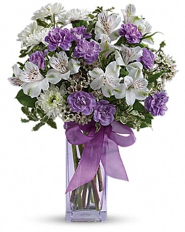 Teleflora's Lavender Laughter Bouquet - Fill her heart with laughter! The ultimate lavender-lover's bouquet this gleeful gift of white and lavender blooms is delivered in a pretty pale lavender vase she'll cherish forever. Lavender organza ribbon adds that gifting touch.
