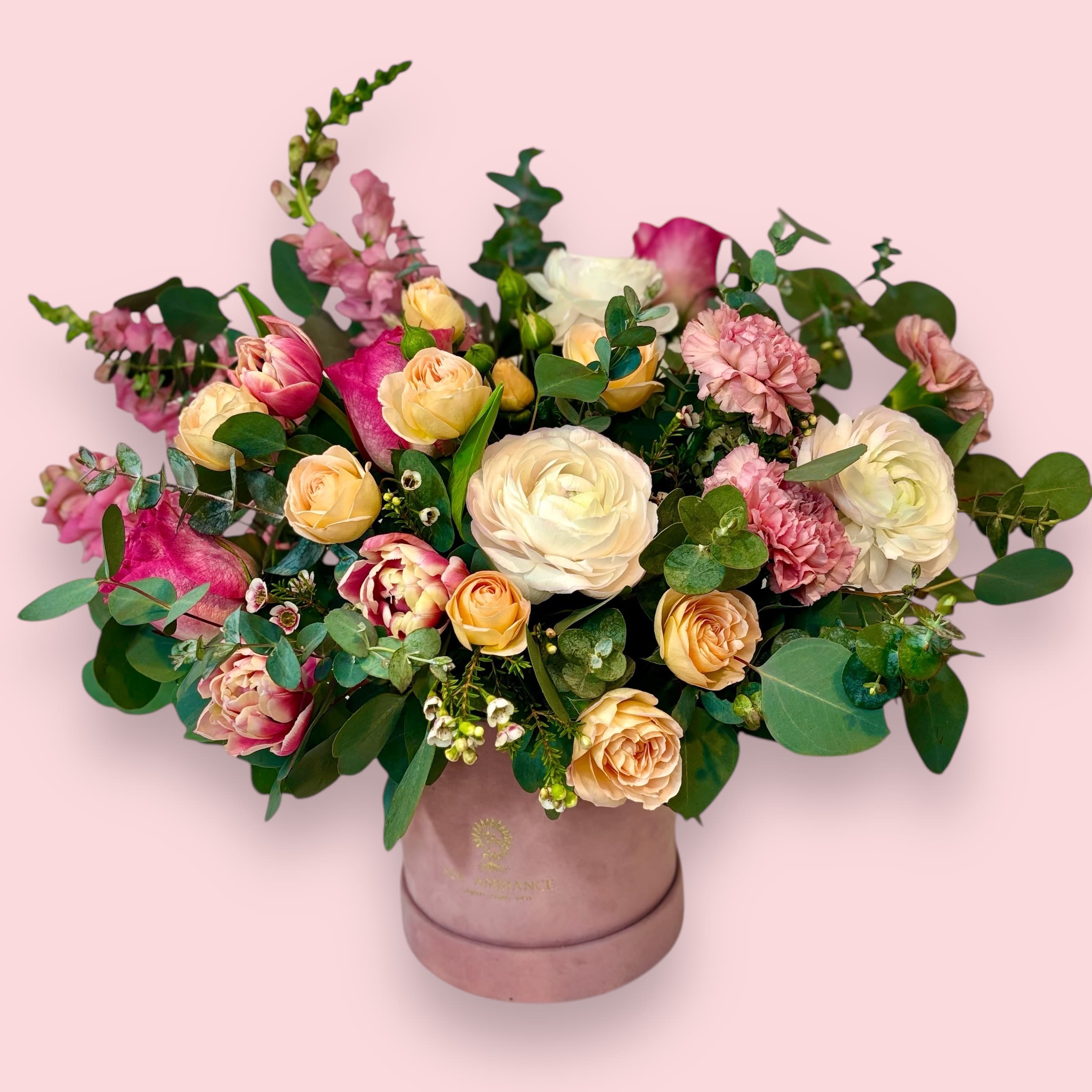 Enchanted - A fun and feminine arrangement of tulips, spray roses, and ranunculus. This velvet dusty pink logo box is  filled with luxurious peach, pink, and white flowers to how much you care. Available year round, but a perfect option for Valentine's Day and Anniversaries.  Ready to bring floral beauty into someone’s world with our romantic box of pink flowers? Order this gift online now or give us a call on (415) 752-2060 if you have a question or special request.