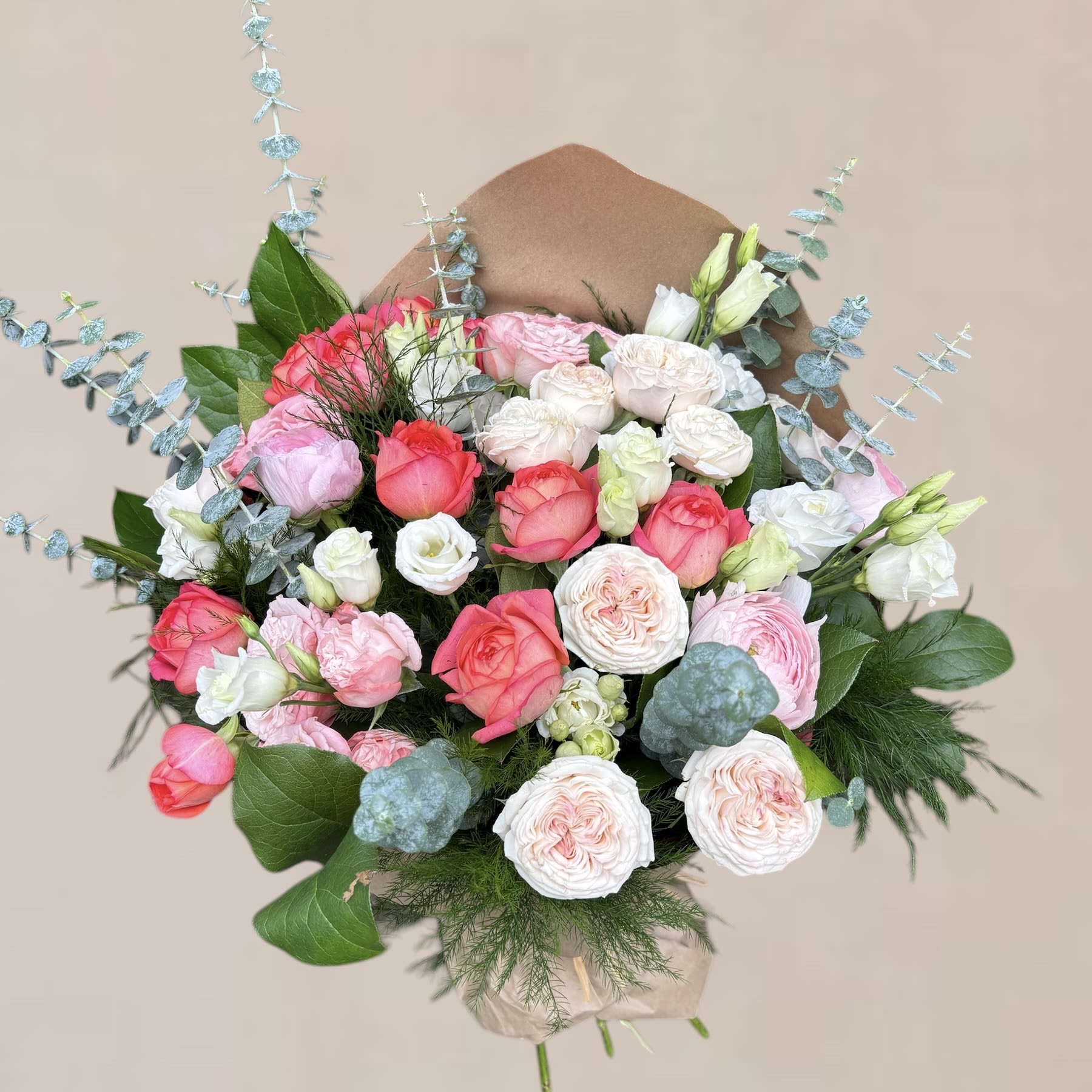 Lacy Bunch - Bouquet made of an array of spray roses, ranunculus, and lisianthus .