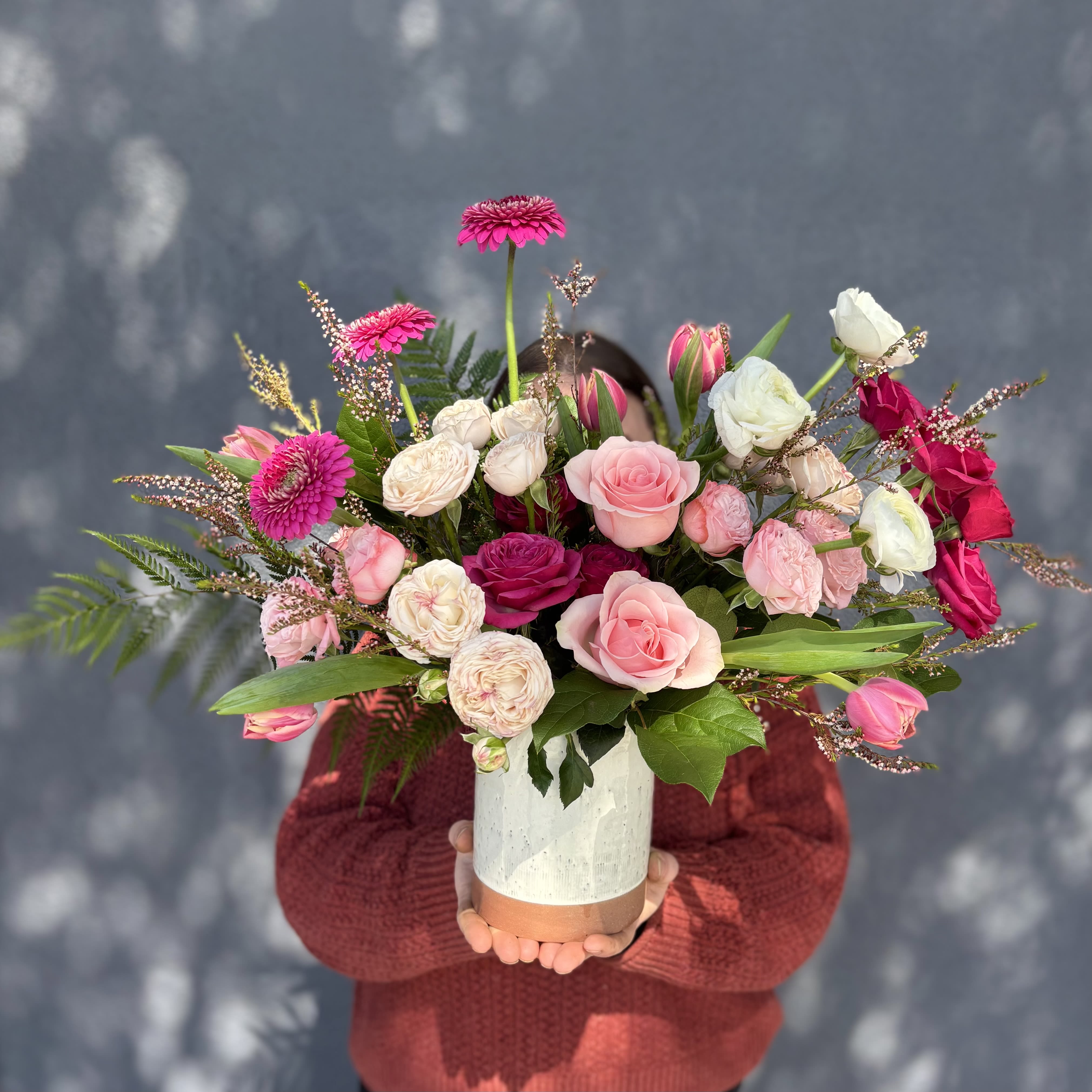 Rosy Cheeks  - A dainty arrangement full of high quality blooms. A perfect arrangement for any occasion. Includes Roses, tulips, and Ranunculus, and Spray Roses.