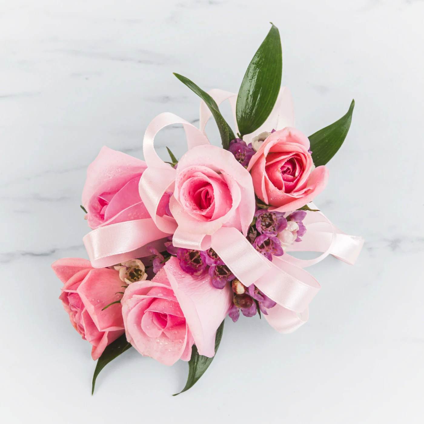 Pink Rose Wrislet Corsage by BloomNation™ Pink Rose Wrislet Corsage by BloomNation™ - A classic pink corsage hand-tied in pink satin that compliments any outfit. A beautiful addition to any prom, formal, or wedding event.