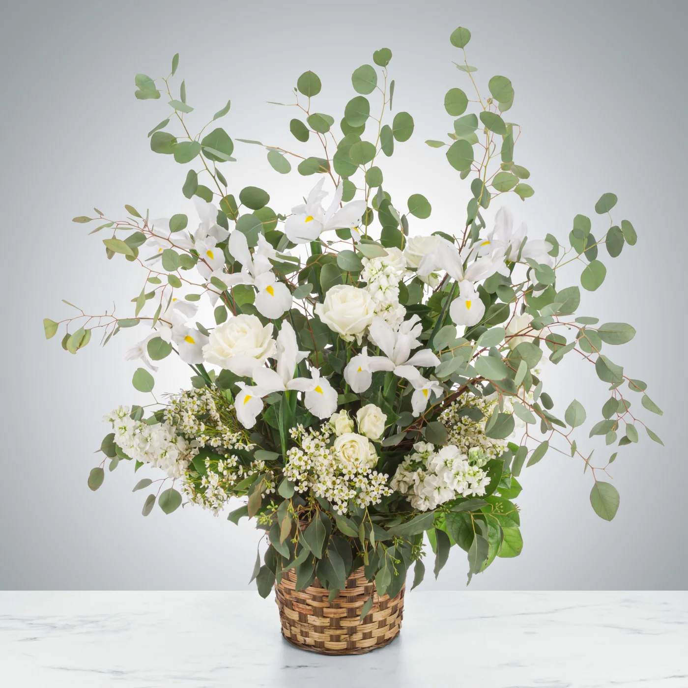 Bright Star by BloomNation™ Bright Star by BloomNation™ - A wispy white and green basket featuring silver dollar eucalyptus and white iris. This arrangement smells lovely and is suitable for any type of ceremony.