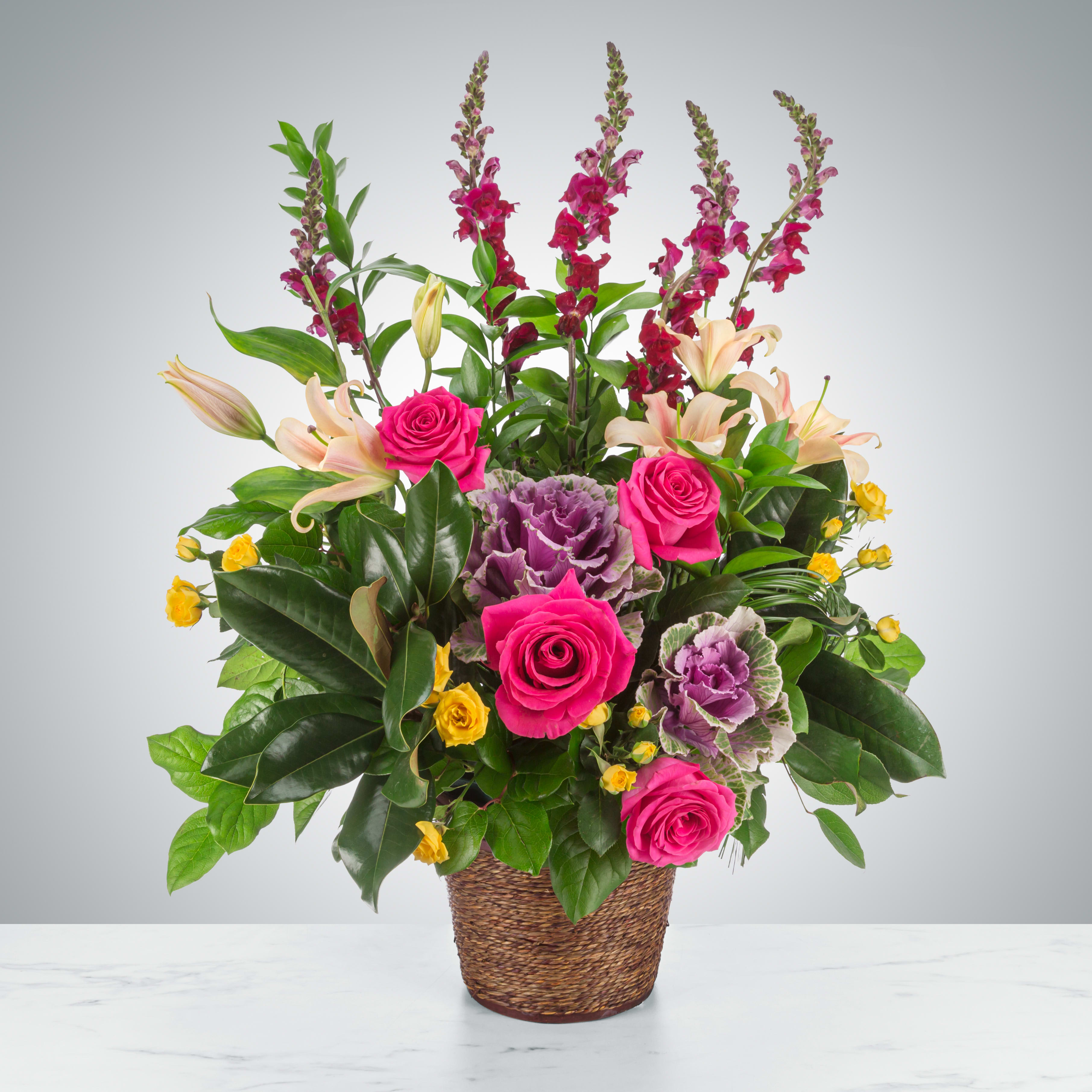 Strength and Silence by BloomNation™ Strength and Silence by BloomNation™ - A multicolored funeral single-sided basket featuring roses, lilies, snapdragons, and more. Suitable for all types of funeral services.