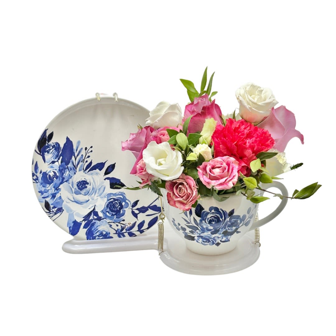 Teacup Garden For Mom - Send warm wishes with this lovely gift bouquet that arrives in a ceramic teacup. This charming, old-fashioned bouquet features pink and peach roses.