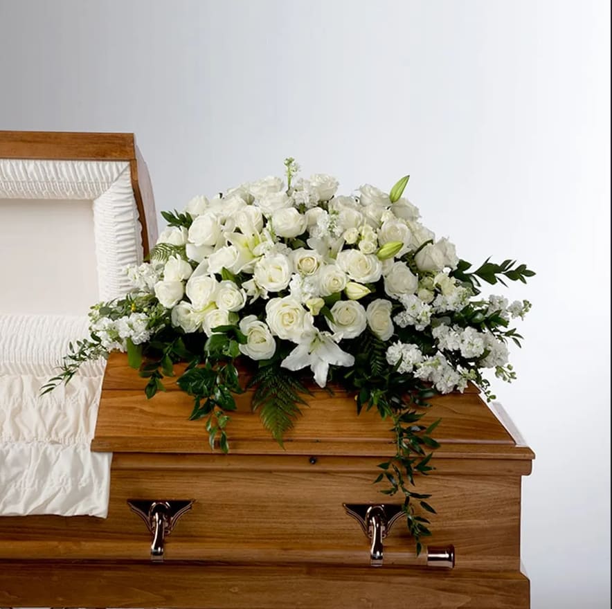 Peace by BloomNation™ Peace by BloomNation™ - An all white tribute, this half casket spray is pure in color and heart. Featuring a variety of white flowers and greenery, this elegant half casket spray compliments the beauty of life.