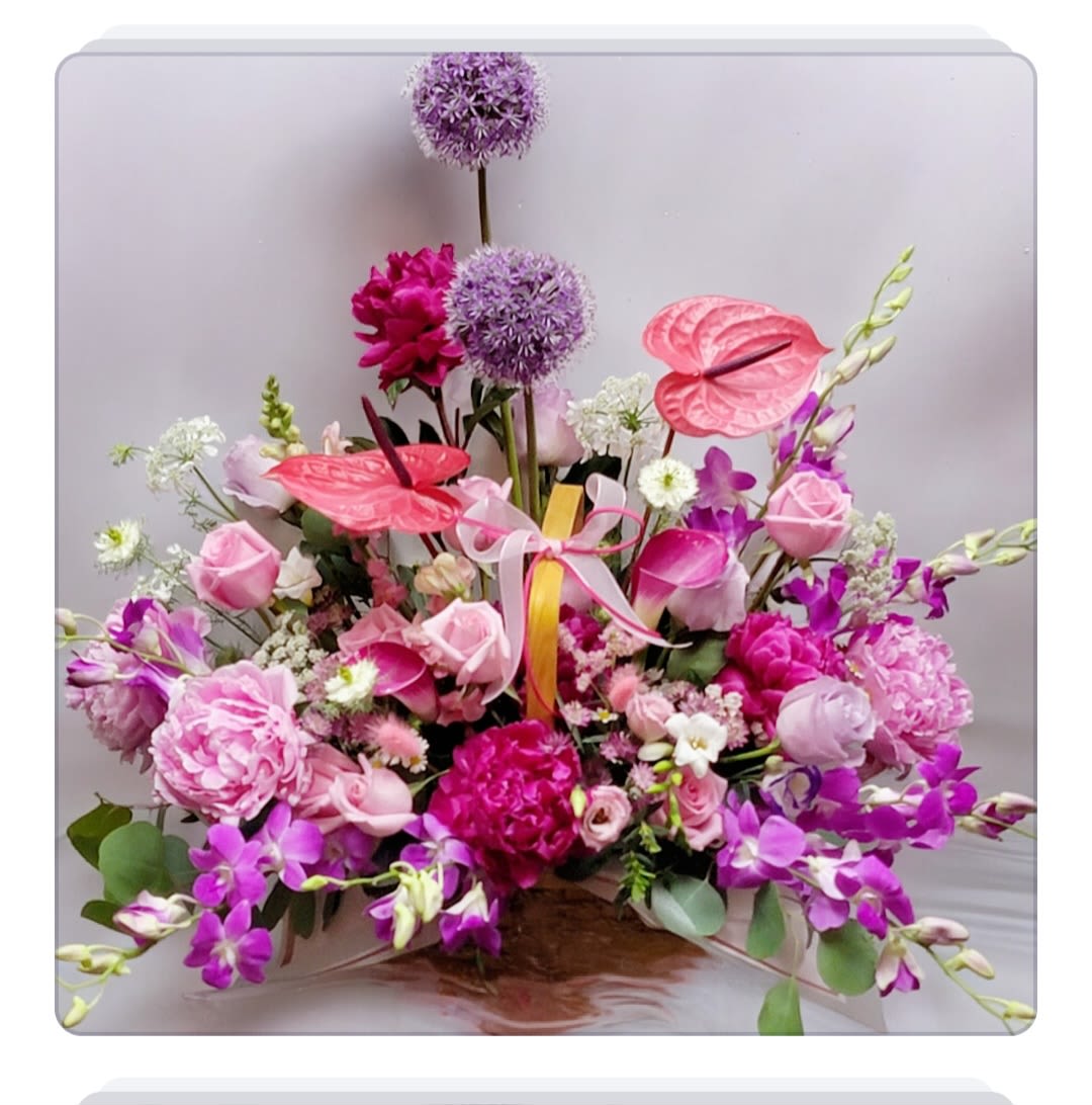 Pink Blossom Flower Basket Pink Blossom Flower Basket - This flower basket makes a great gift for any occasion: birthdays, anniversaries, or just to give to a loved one. The basket is large in size and is arranged in pink and purple tones. It will be made by a florist with the same style and flowers as shown in the photo, but other flowers can be substituted depending on the season. Usually better value flowers are used.