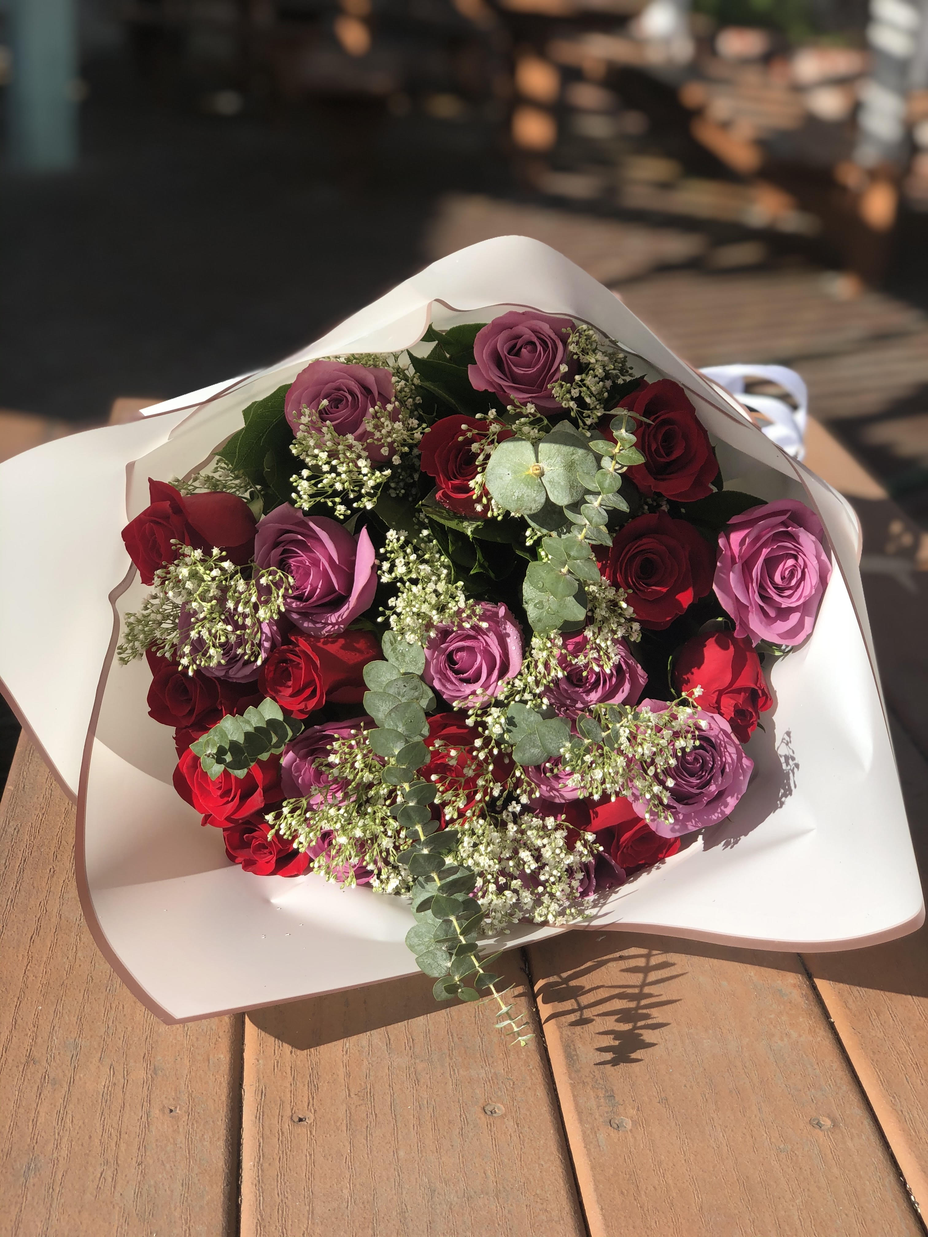 2 Dozen Red and Purple Roses Wrap 2 Dozen Red and Purple Roses Wrap - - 12 Red Roses - 12 Purple Rose - White Filler - Seasonal Greens - Papers and Bow