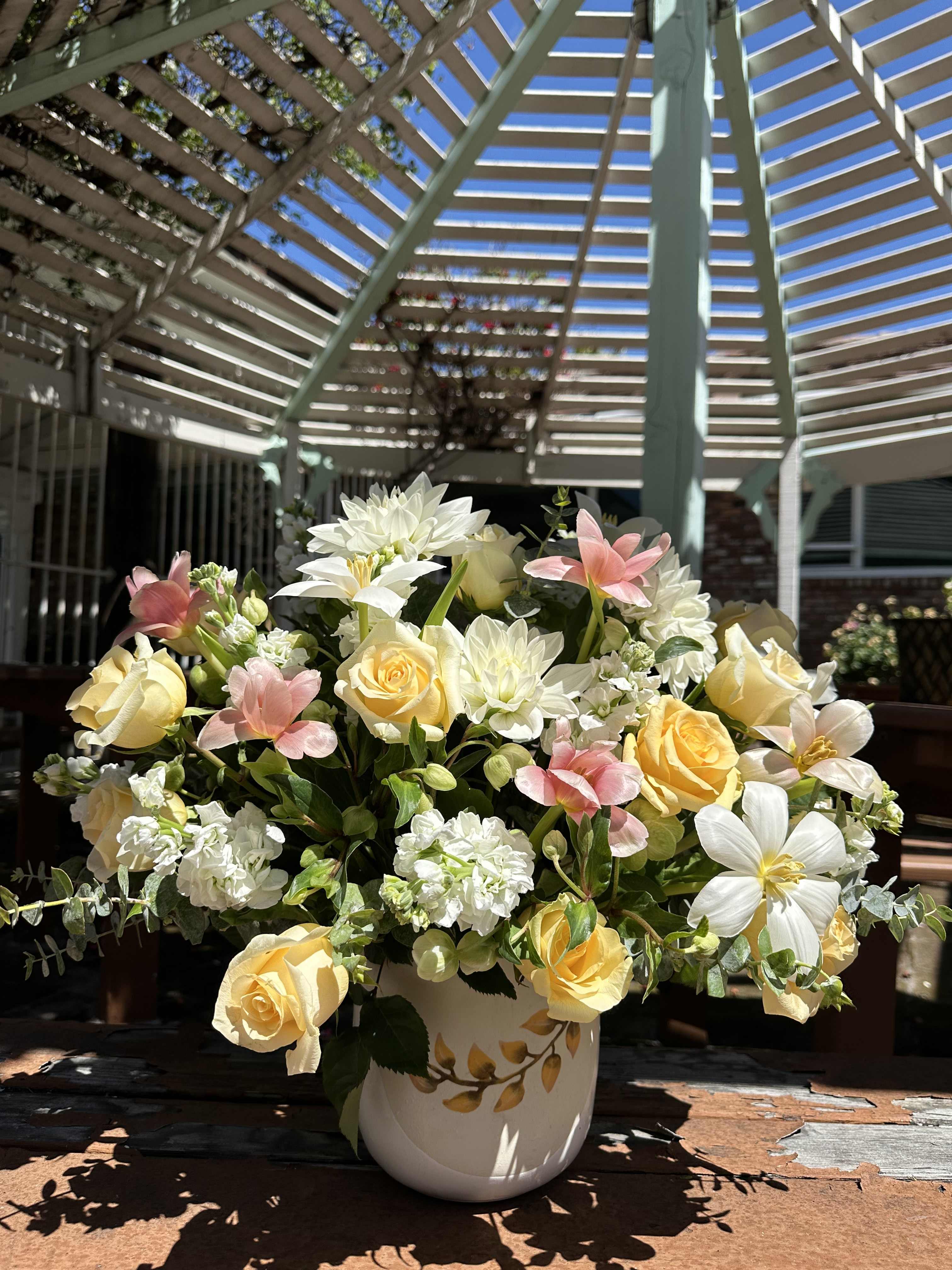 Spring Into Summer Spring Into Summer - Includes: -Beige roses - White Dahlia or Spider Mum replacement - White Stock or White snap replacement - Pink tulips - White tulips