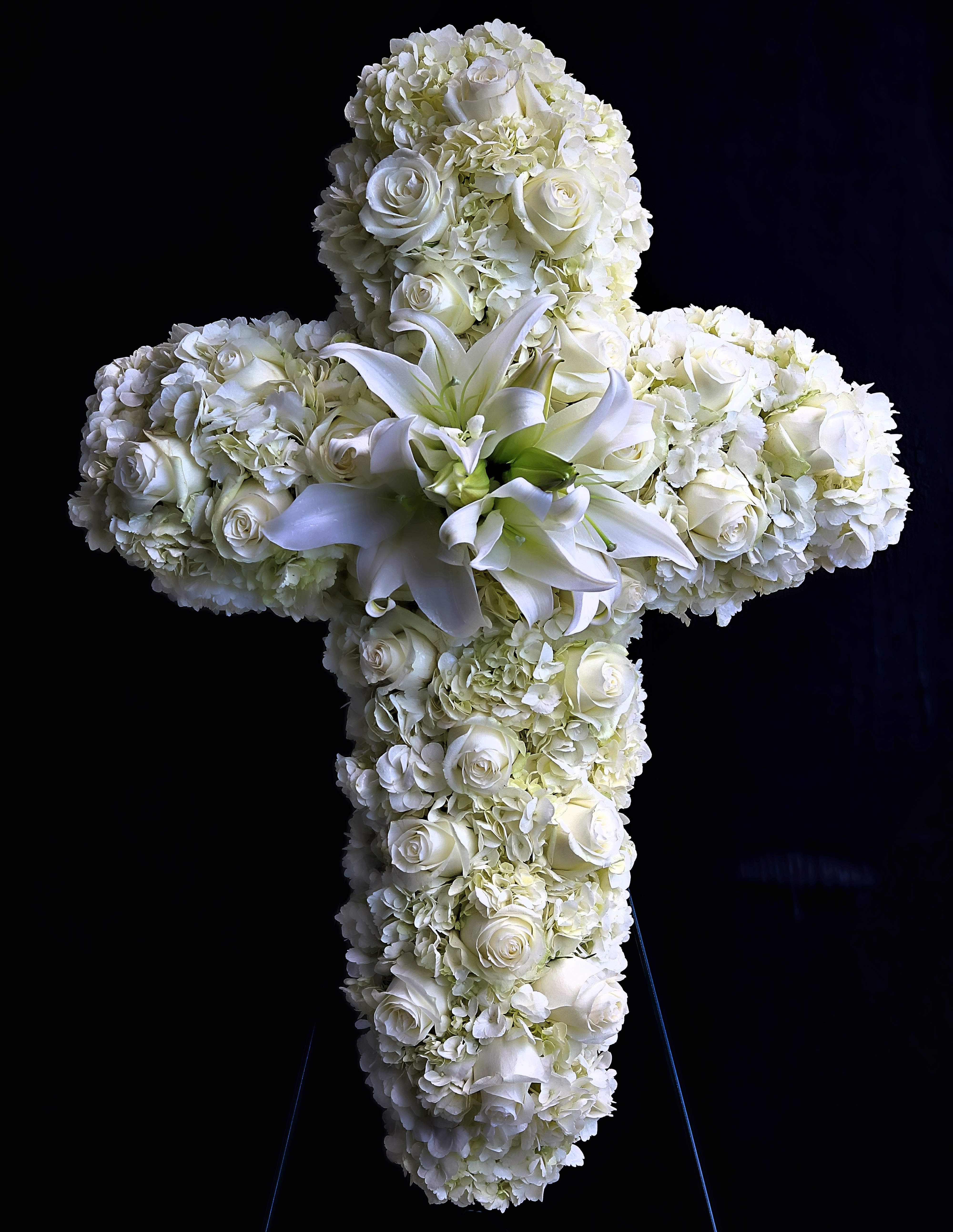 in loving memory in loving memory - An all white tribute, this white cross funeral spray is pure and tranquil. Featuring a variety of white flowers, this elegant easel compliments the beauty of life.