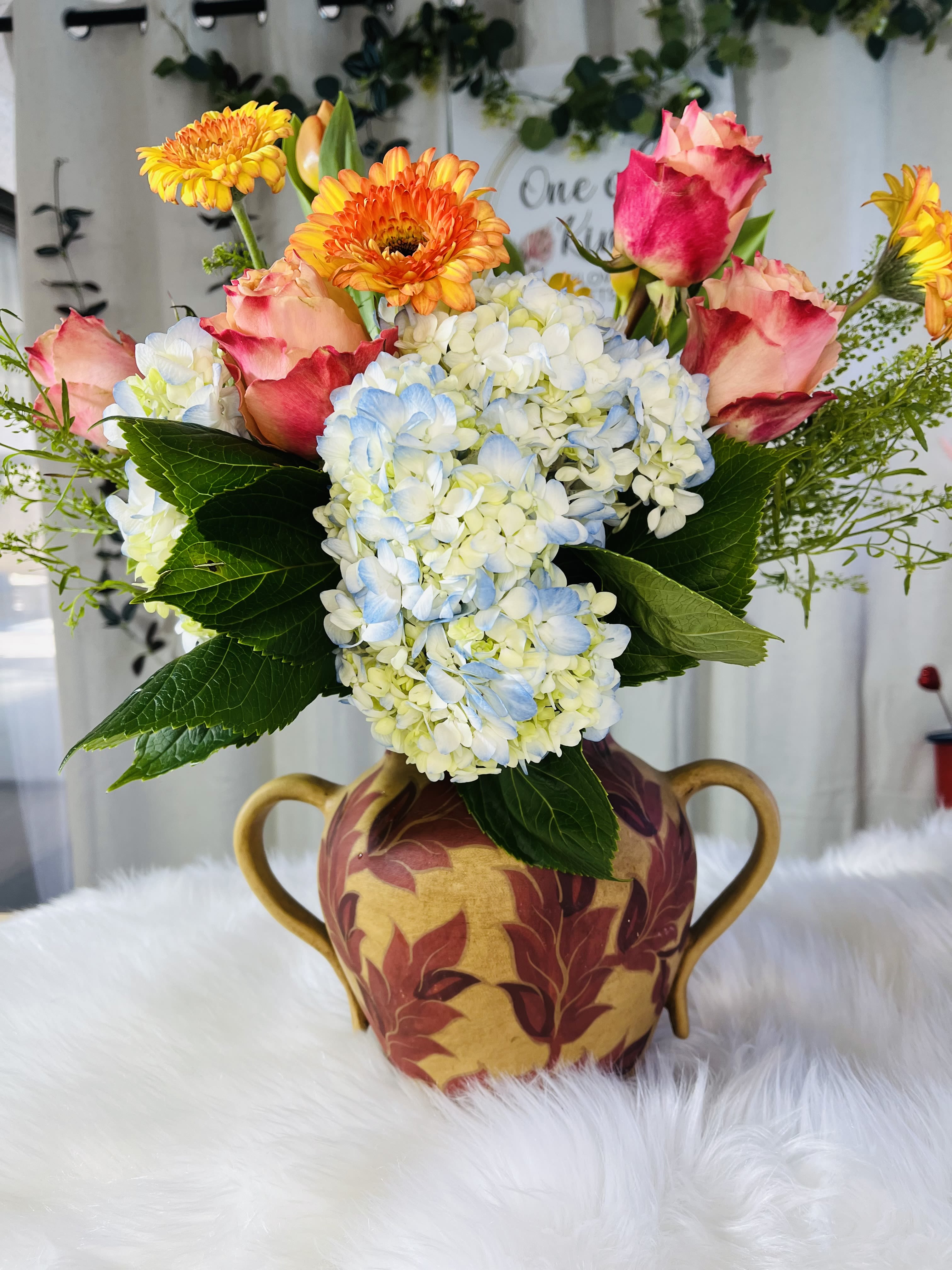 Amaranto - A creation full of color and life to brighten the day of that special person.  Decorated ceramic container approximate height 20”
