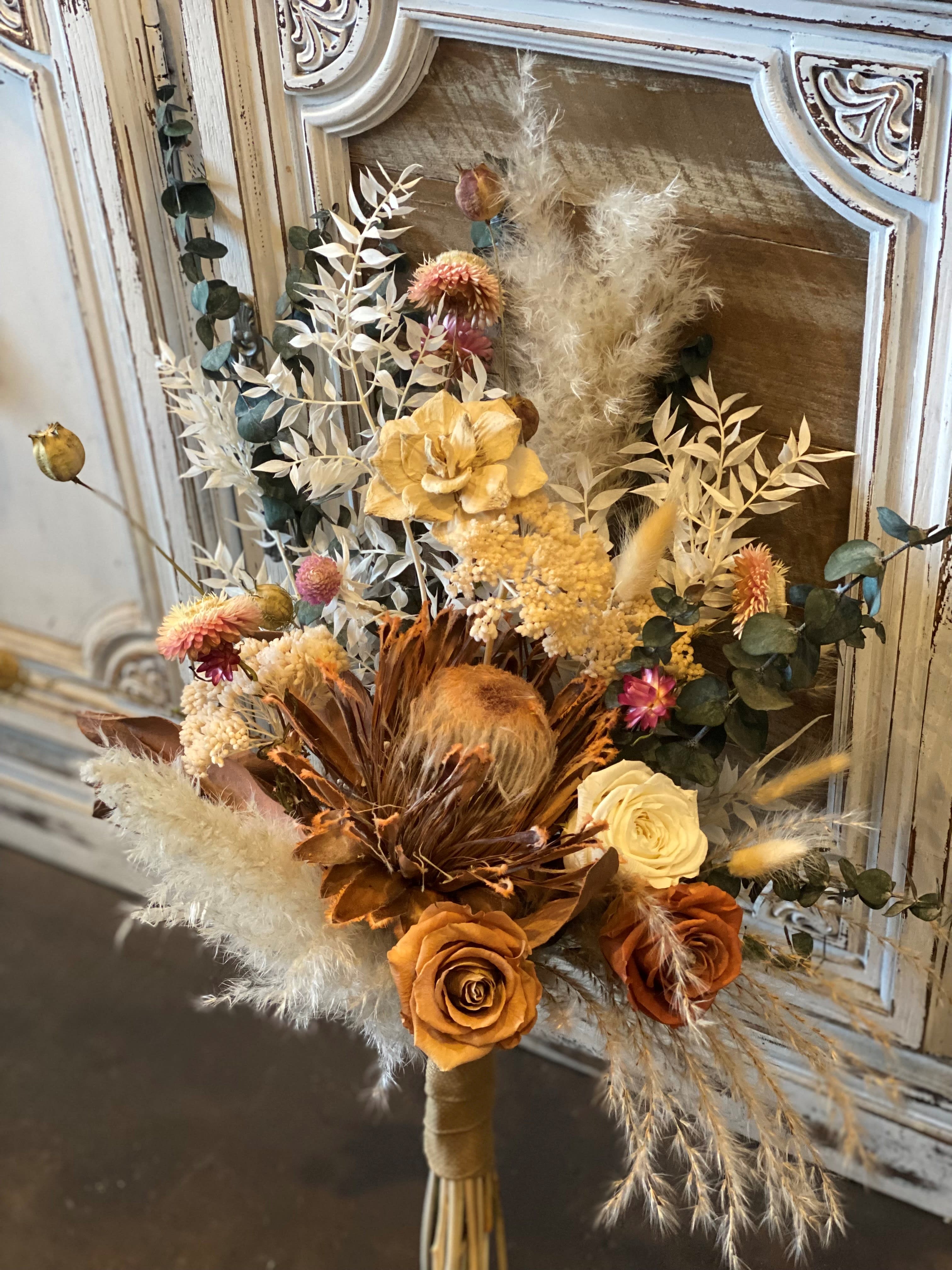 King Protea King Protea - A beautiful and unique bouquet with a mix of lovely dried flowers and centered with an amazing dried King Protea. This arrangement is perfect that person who loves a modern bouquet that uses are select dried flowers which are dried in house.