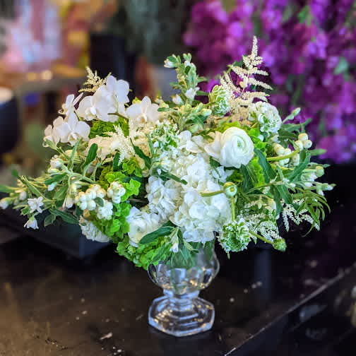 Crystal English Garden Crystal English Garden - Green and white garden flowers including ranunculus astilbe and finer varieties elegantly arranged in a heavy crystal vase.