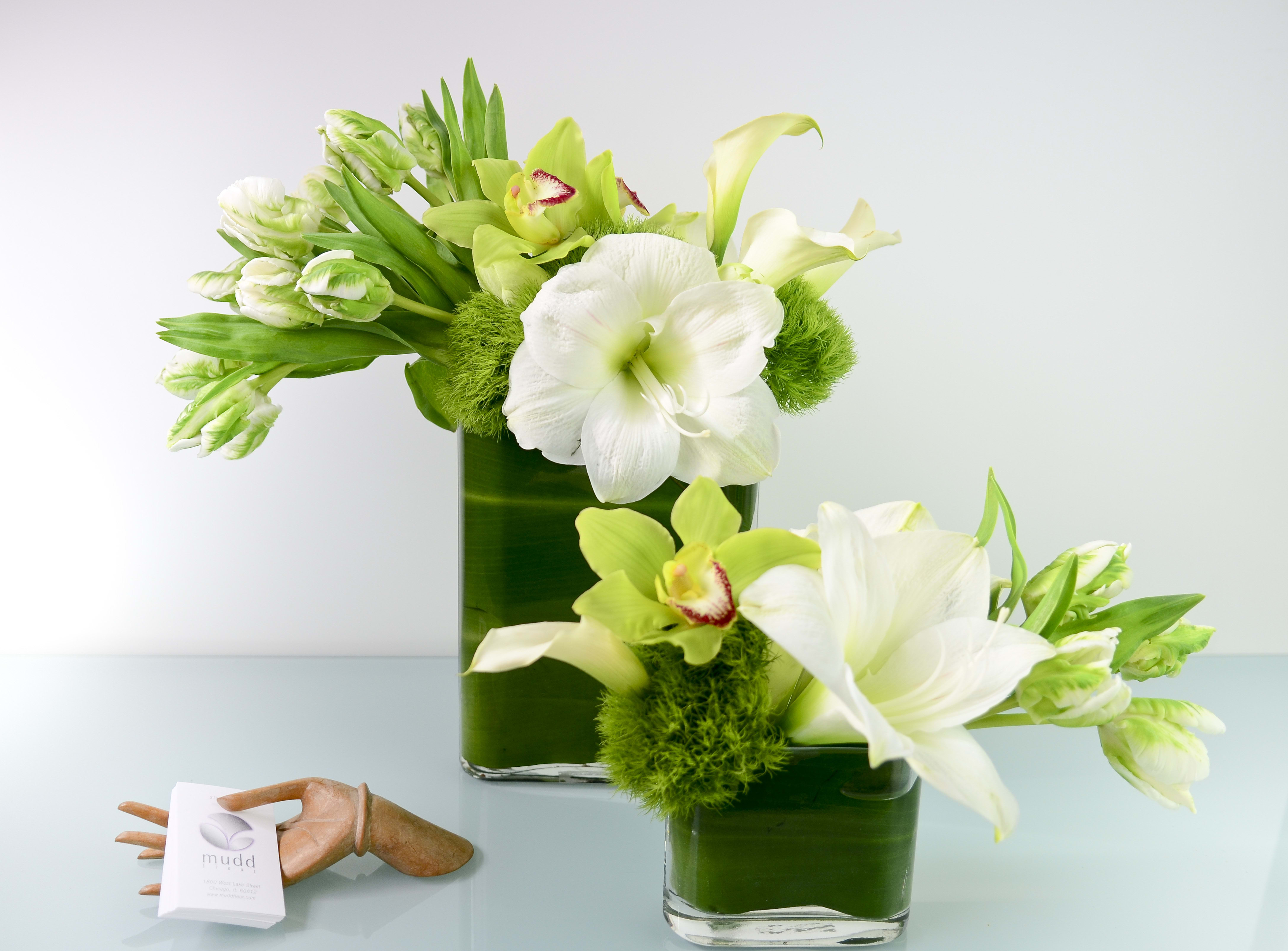 Elegant White and Green Duo Elegant White and Green Duo - Designers Choice! Our Mudd Fleur signature collection of two vases hosting seasonal green and white flowers. Elegant simple, perfection!