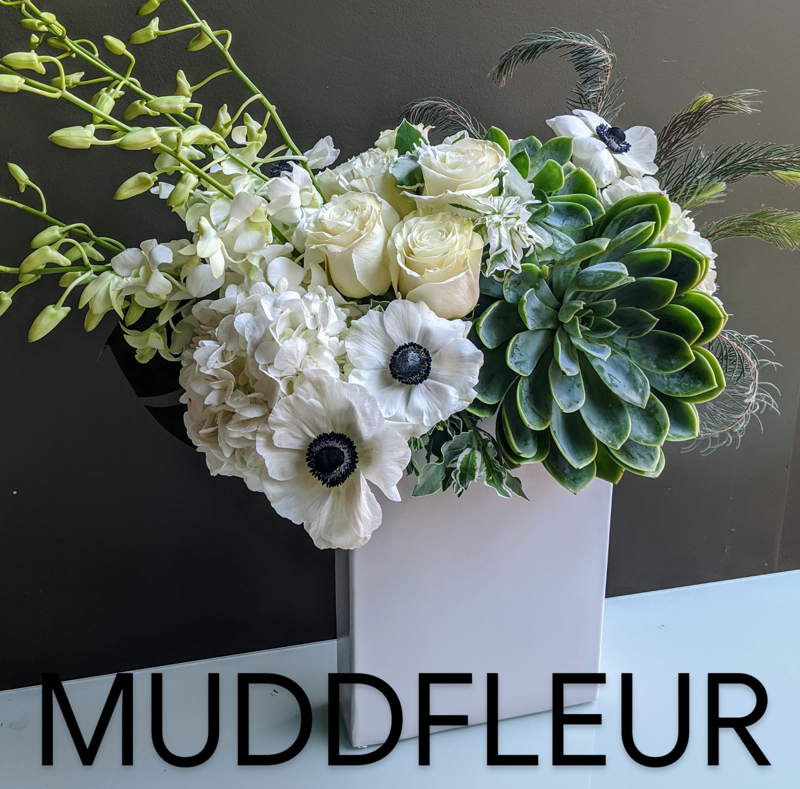 White Moderna Gift Arrangement with &quot;Best of Market&quot; Flowers - Our Designers will handpick the best flowers at the market, and create a unique modern arrangement similar to the one shown in a tall white ceramic vase shown here with giant succulent, orchids, hydrangea, dendrobium orchids and anemones.   