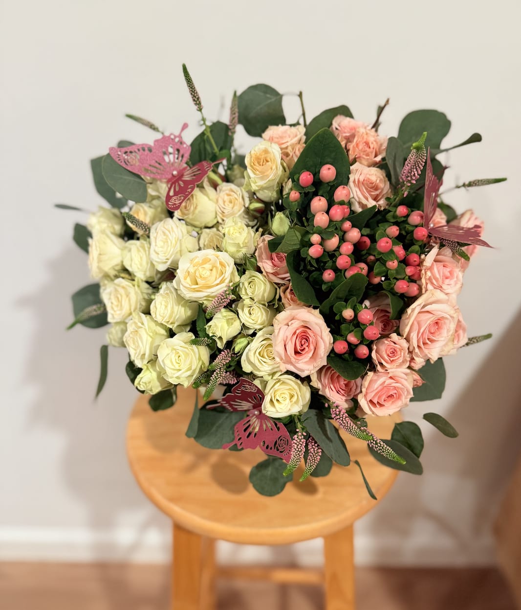 Large Hybrid Heart-Shaped Arrangement with Baby Roses &amp; Exotic Flowers - Make a grand gesture with our Large Hybrid Heart-Shaped Arrangement. This breathtaking, oversized design features an enchanting mix of soft pink and white baby roses, complemented by lush greenery and vibrant exotic flowers. The heart-shaped arrangement symbolizes deep affection, while the metallic pink butterflies add a touch of whimsy and elegance.  The lush baby roses create a delicate, romantic base, while the exotic flowers bring boldness and vibrancy, making this arrangement a stunning statement piece for any occasion. Whether it’s a special anniversary, birthday, or a romantic surprise, this large, show-stopping arrangement is the perfect way to convey love and admiration.  Elegant. Whimsical. Grand. A perfect blend of natural beauty and charm, designed to leave a lasting impression. 
