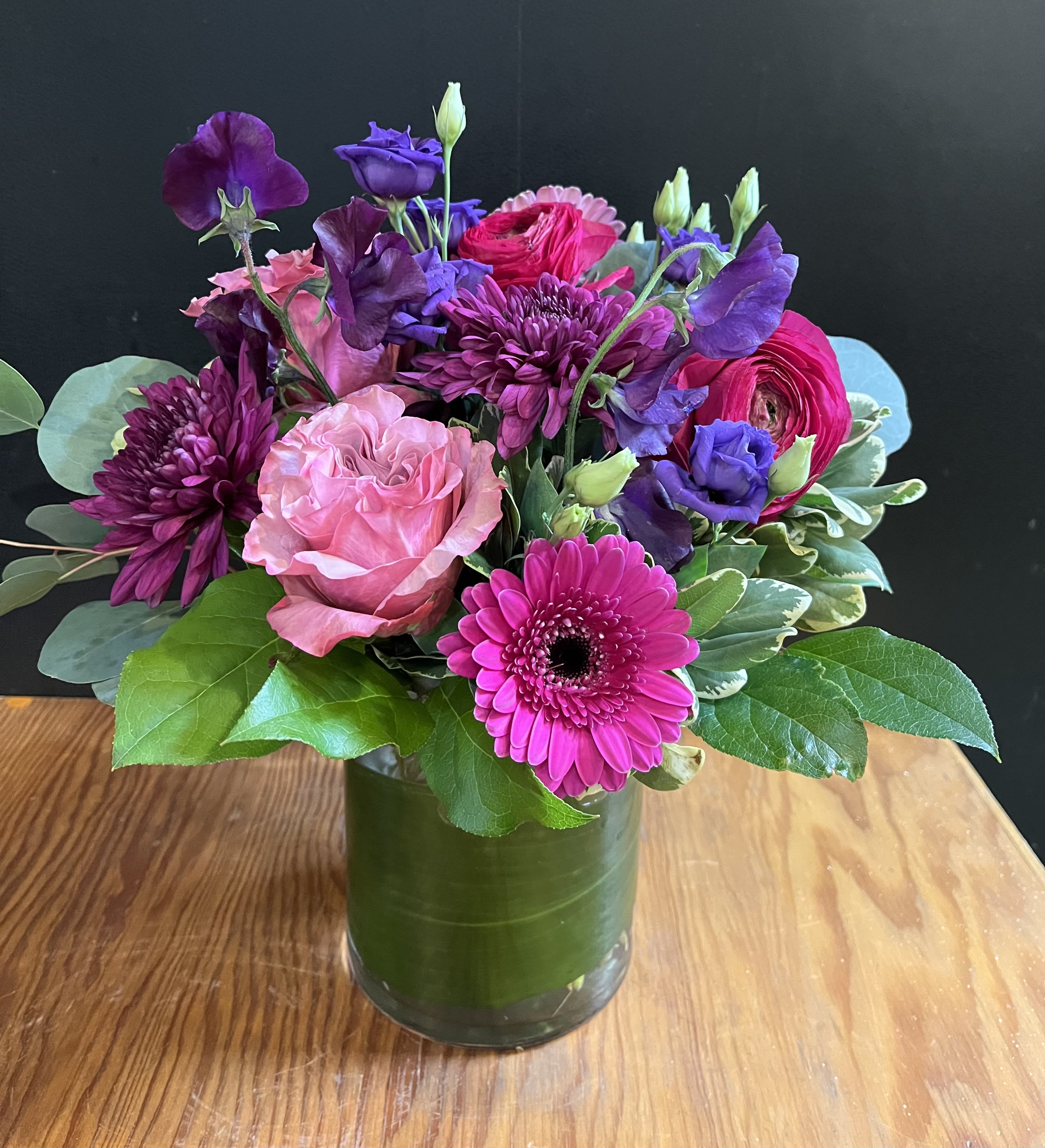 Passion Passion - Deep colors , purples and hot pinks convey a message of love and passion. (Flower variety will vary )gathered together in a glass vase. Approx 13”h