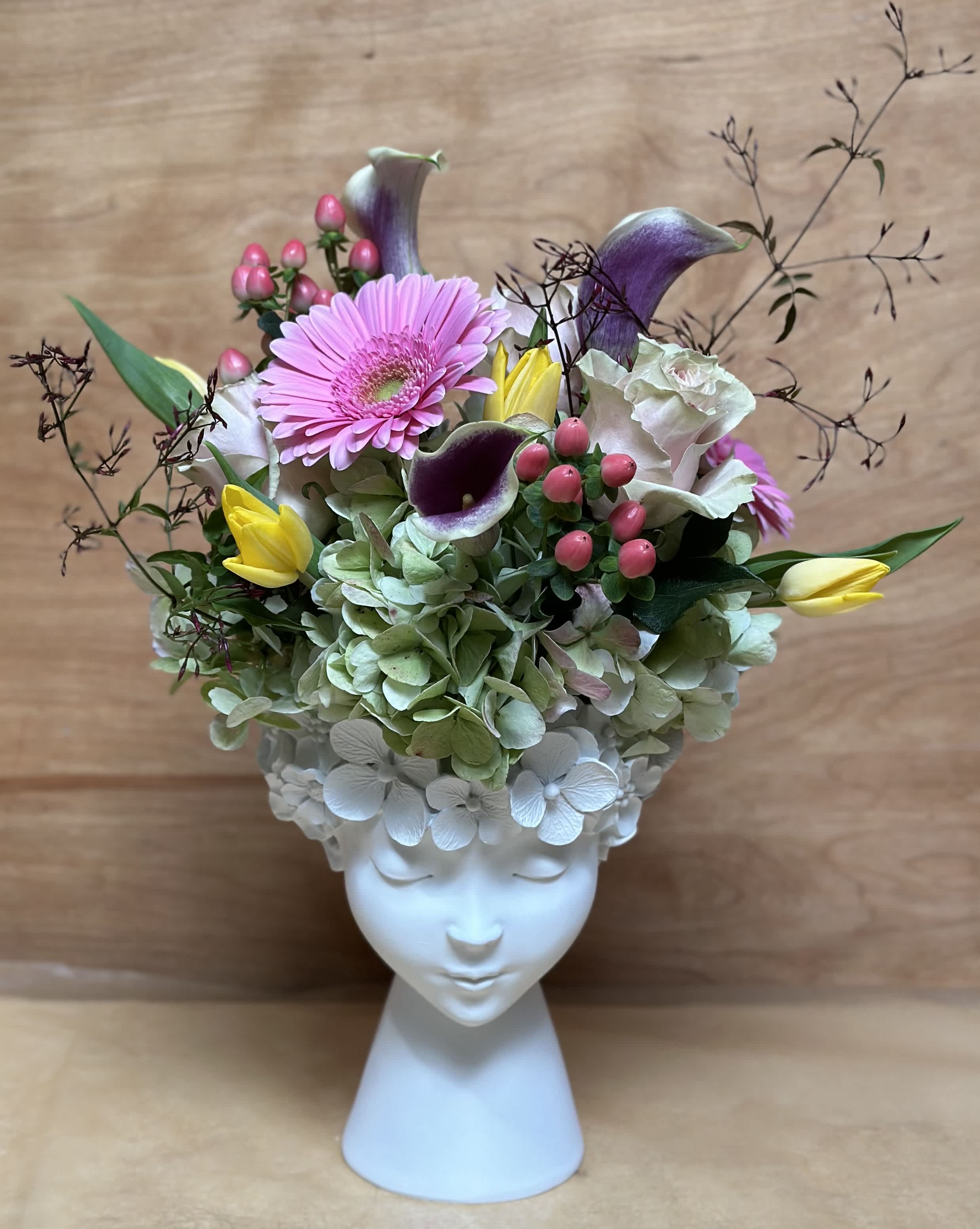 Floral Goddess Floral Goddess - Seasonal Florals will be gathered to create a beautiful display in our floral goddess vase. The selection of flowers will vary in each arrangement based on availability. Approx. Height ; 18"