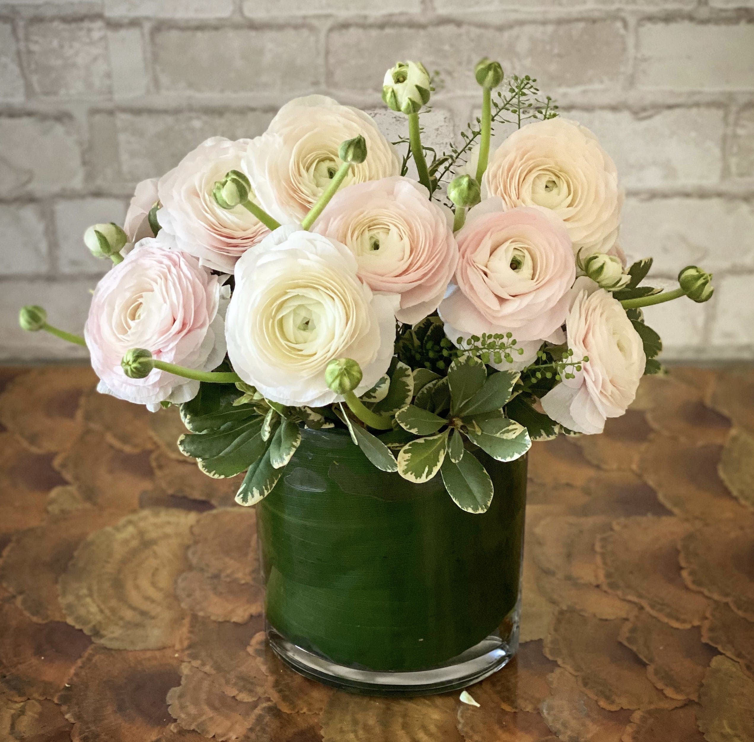 The Finer Things The Finer Things - Gorgeous, elegant, luxe ranunculus arranged in a medium height fish eye vase.