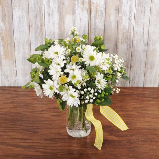 Darling Daisies - This adorable floral arrangement comes in a mason jar filled with daisies, babies breath and more!
