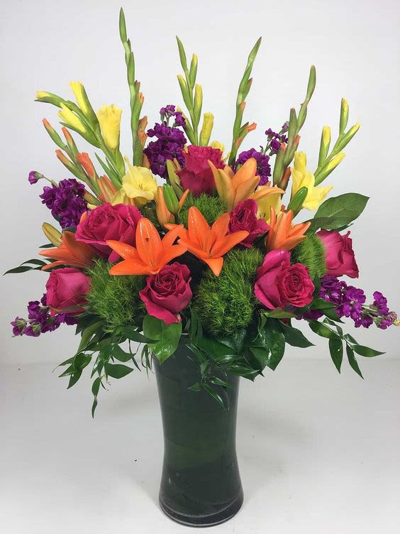 Bright and Vibrant Vase Bright and Vibrant Vase - A colorful mix that includes Glad, Lilies, Roses and stock. A great Summery gift for a birthday of Anniversary.