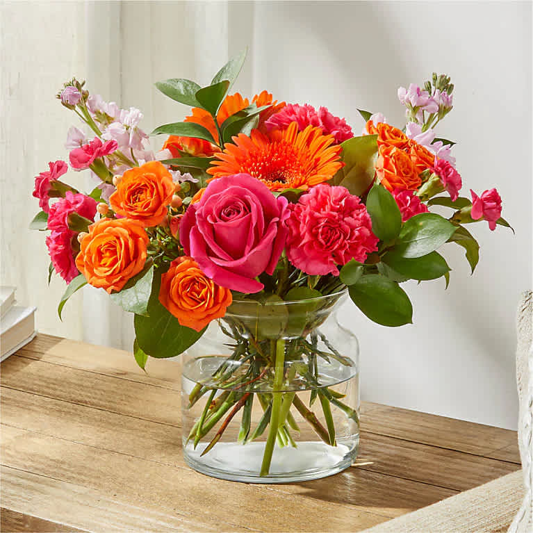 Fiesta Bouquet - The Fiesta Bouquet is composed of a lively mix, fit to celebrate any and every moment. With a combination of vibrant flowers, this florist–designed arrangement brings a pop of color and a burst of excitement as soon as it arrives.  Please Note: The bouquet pictured reflects our original design for this product. While we always try to follow the color palette, we may replace stems to deliver the freshest bouquet possible, and we may sometimes need to use a different vase.