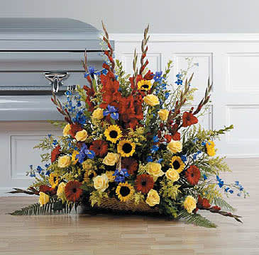 Colorful Wicker Basket -B6 - SKU: Funeral-5  This traditional arrangement with its yellow, red and blue flowers will send your most comforting wishes to family and friends. Included are red gladiolas, sunflowers, delphinium, yellow roses and red gerbera daisies.