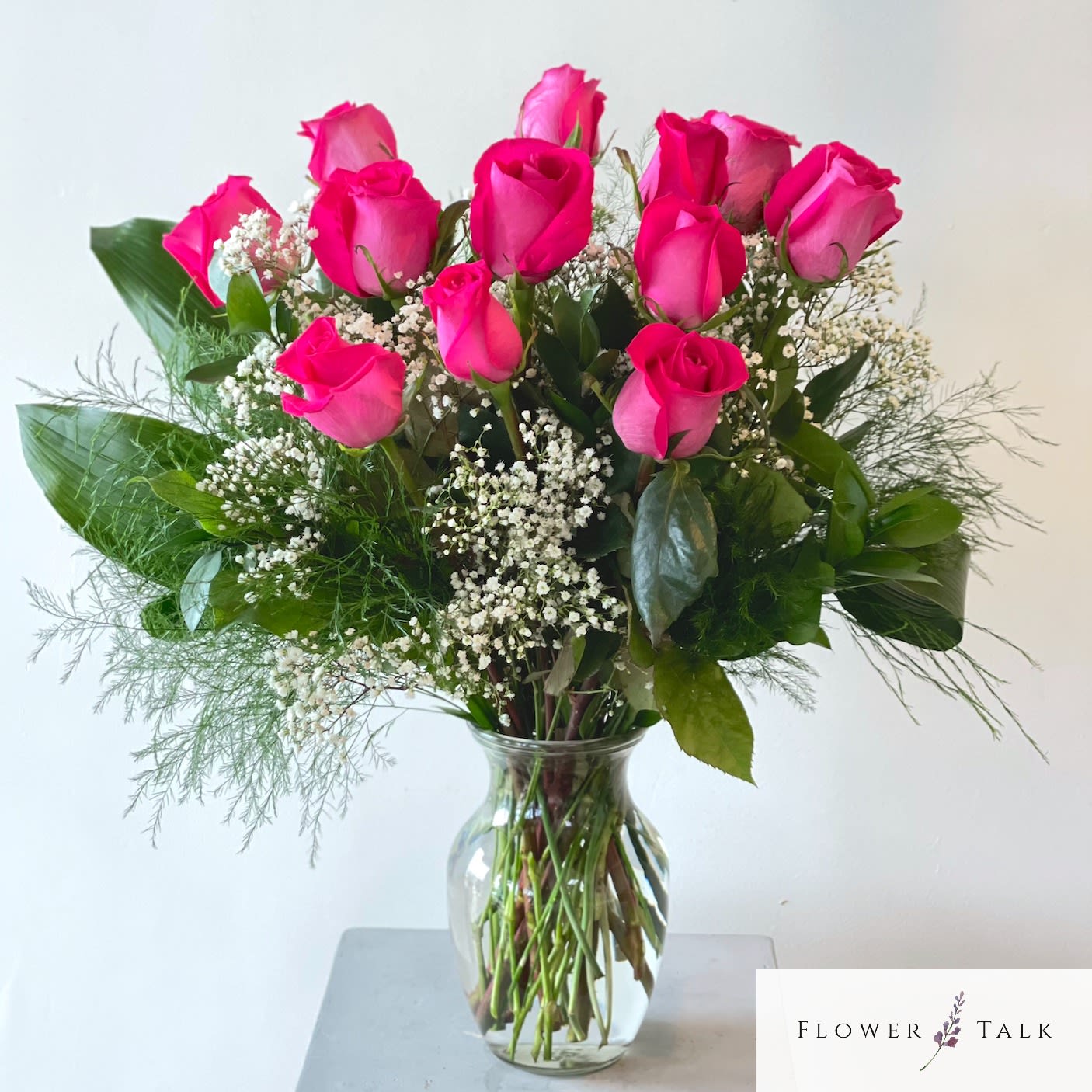 Dozen Hot Pink Roses Dozen Hot Pink Roses - Dozen hot pink roses in a vase. Standard: 12 roses Deluxe: 18 roses Premium: 24 roses