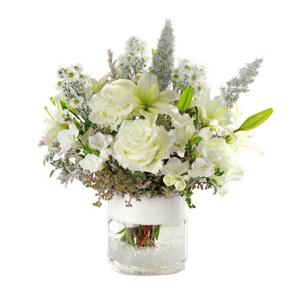 Snow-Capped Glory - Mirroring a snow-capped mountain, our green and white arrangement of roses, Asiatic lilies, freesia and seeded eucalyptus will cap off every holiday celebration!