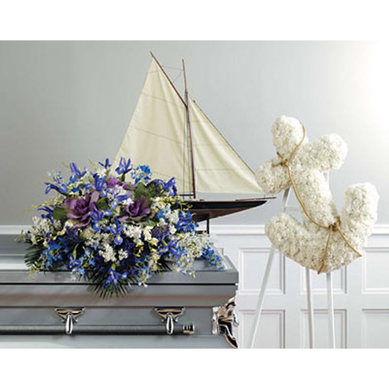 Nautical Tribute Nautical Tribute - All white anchor and a casket spray of blue and white flowers.