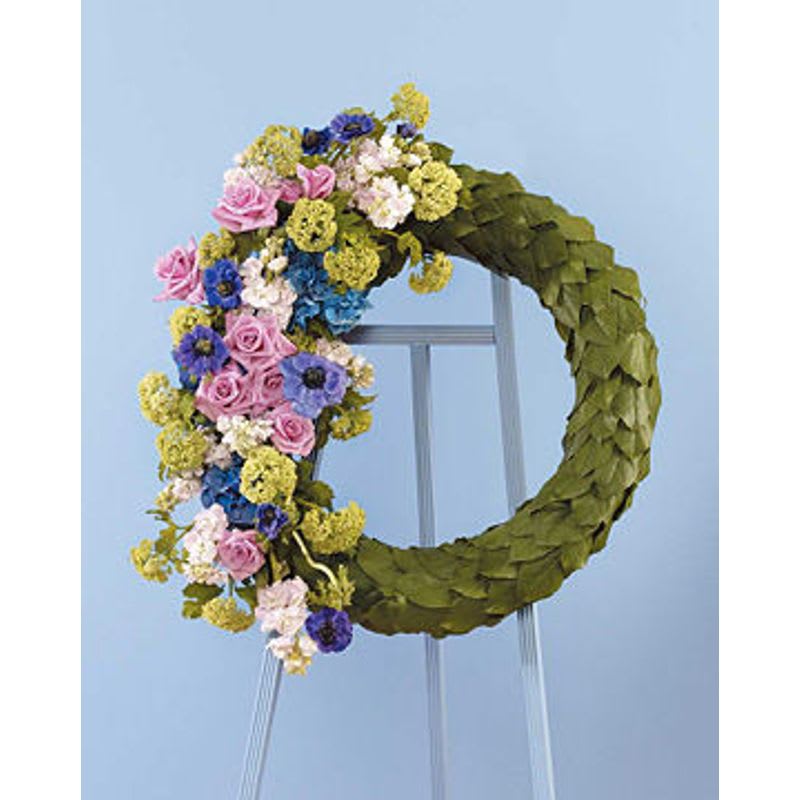 Salal Wreath Salal Wreath - Wreath on an easel covered with salal leaves and cluster of beautiful yellow blue and green blooms.