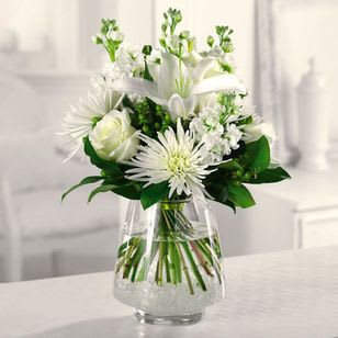 White Wonder - A white Oriental lily surrounded by roses, Fuji mums and white stock is wondrous and wonderful!