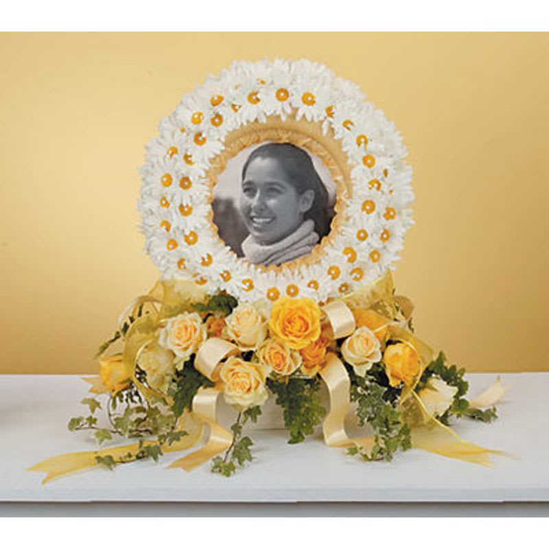 Picture Memorial Picture Memorial - A wreath of white gerbera daisies surrounds the pictuere of your loved one with yellow roses at the base.