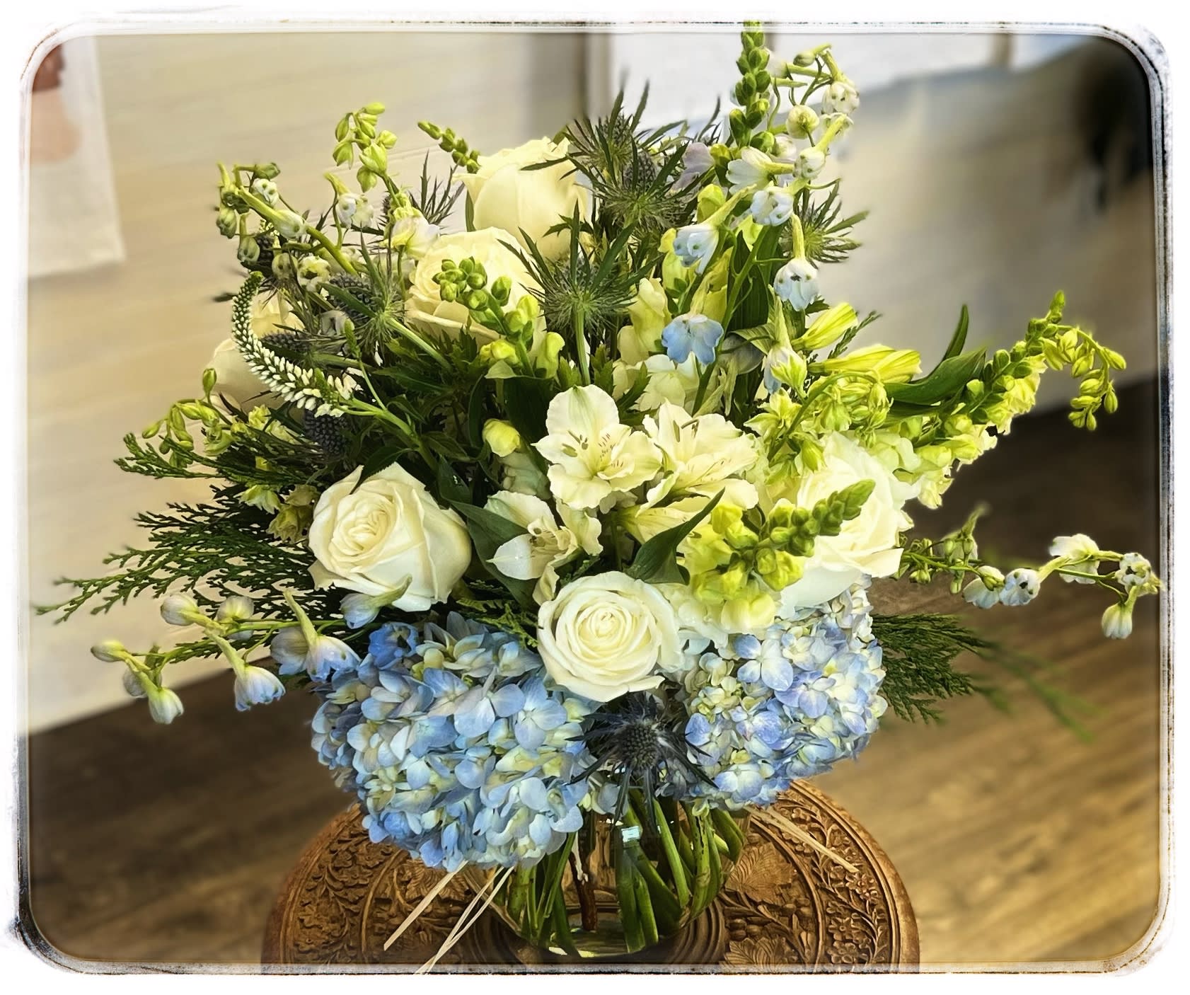 Jackie O Jackie O - This arrangement contains blue hydrangeas, white roses and so much more.