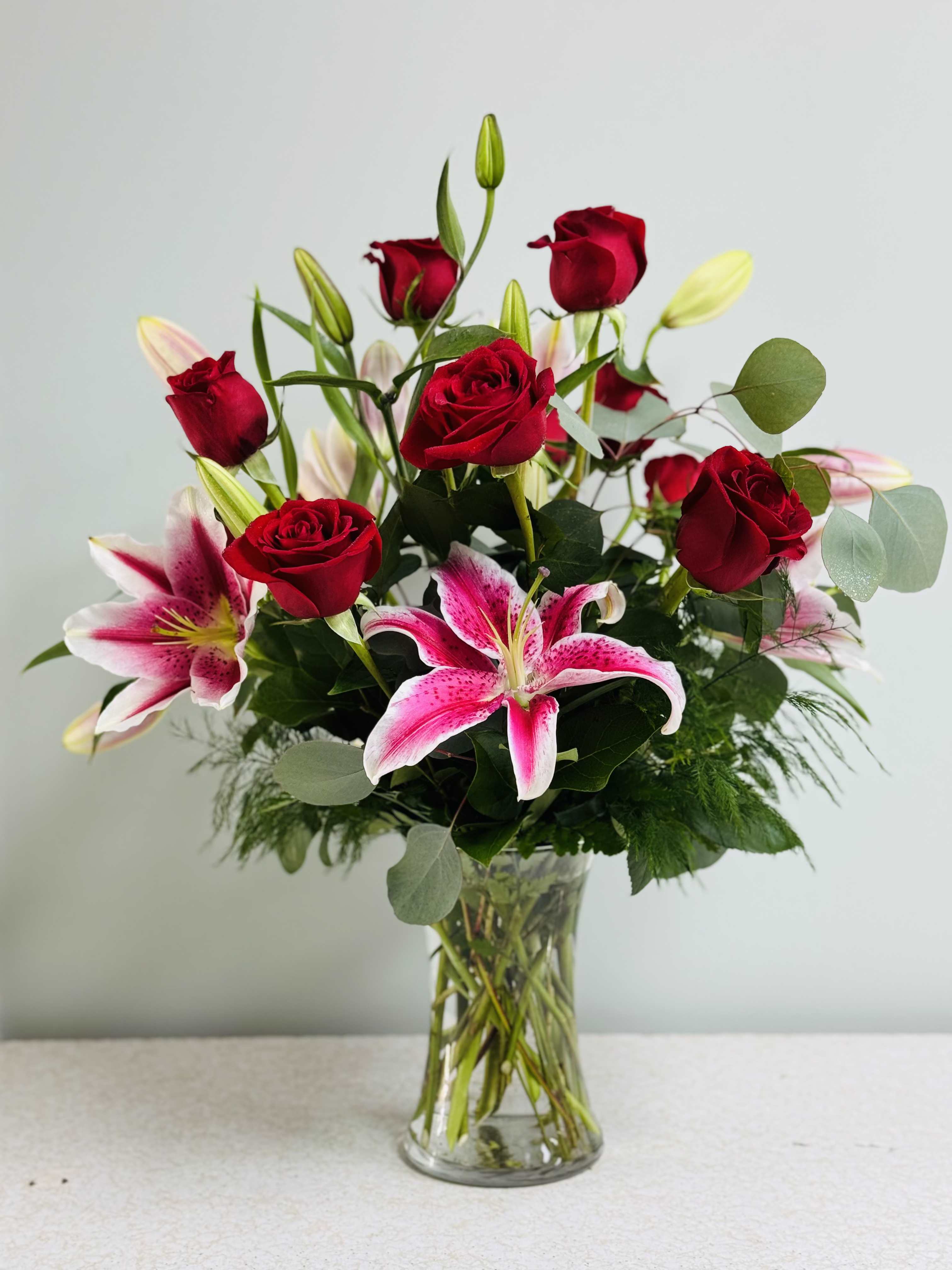 Always and Forever - This signature arrangement features a dozen roses, three star-gazer lillies, two types of greens, and filler. It's a real beauty and so fragrant! If only you could smell these through the website. 