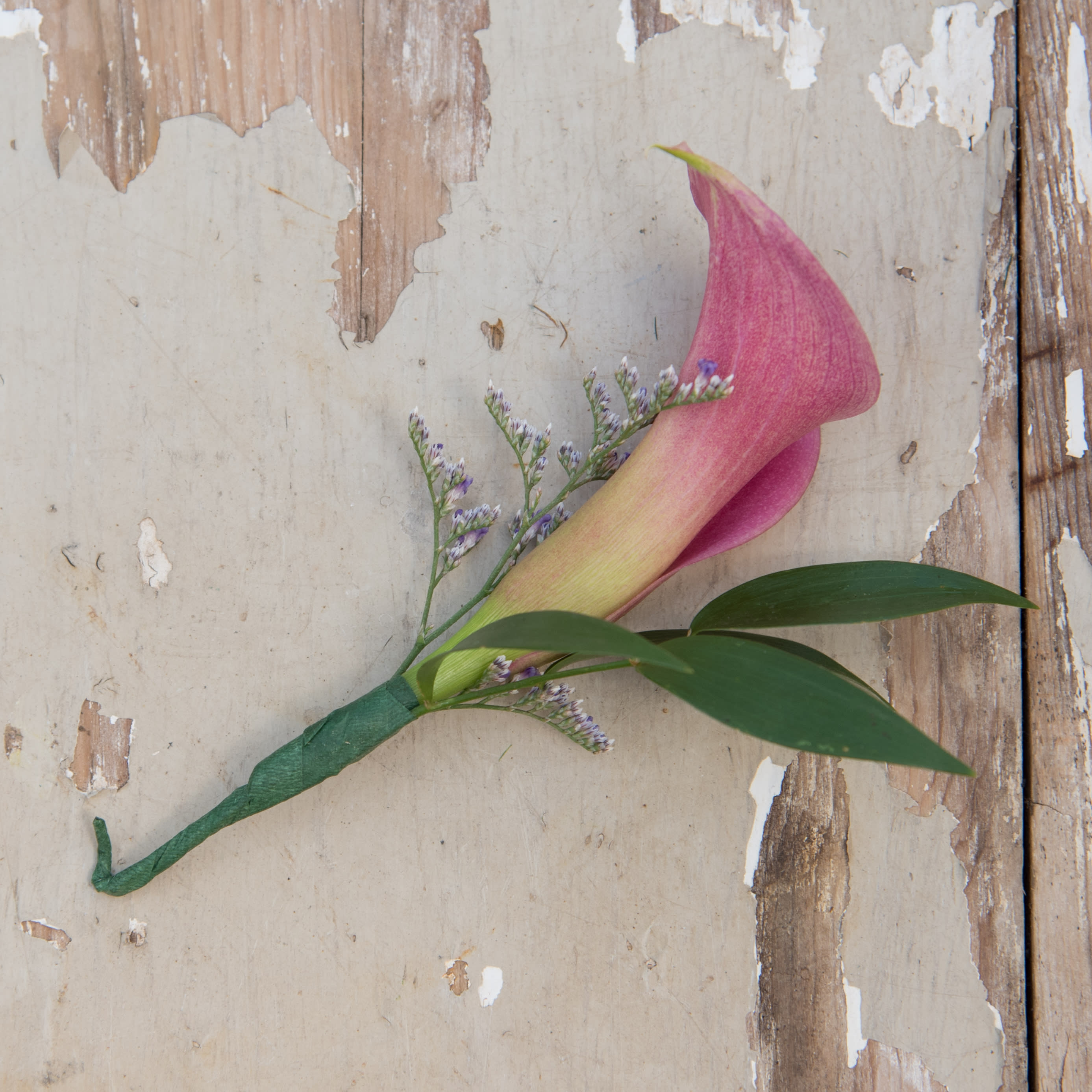 Calla Lily Boutonniere Calla Lily Boutonniere - A gorgeous calla lily accented with unique greenery.