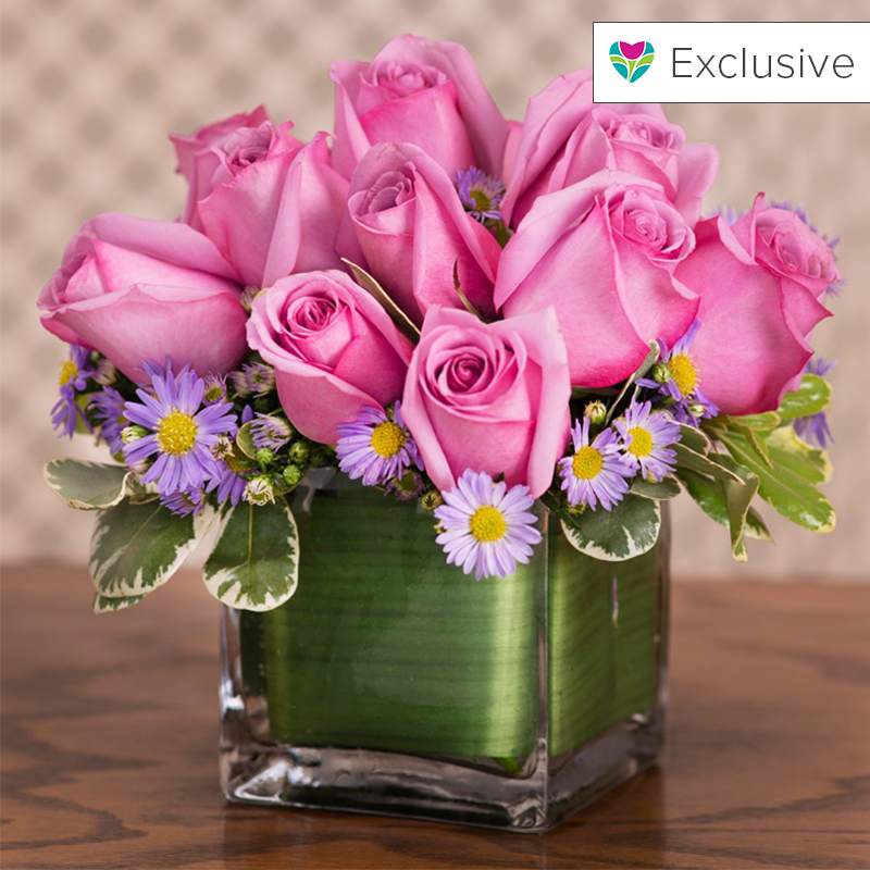 Lavender Rose Dream Lavender Rose Dream - All Lavender Roses with mixed greens in a glass cube vase
