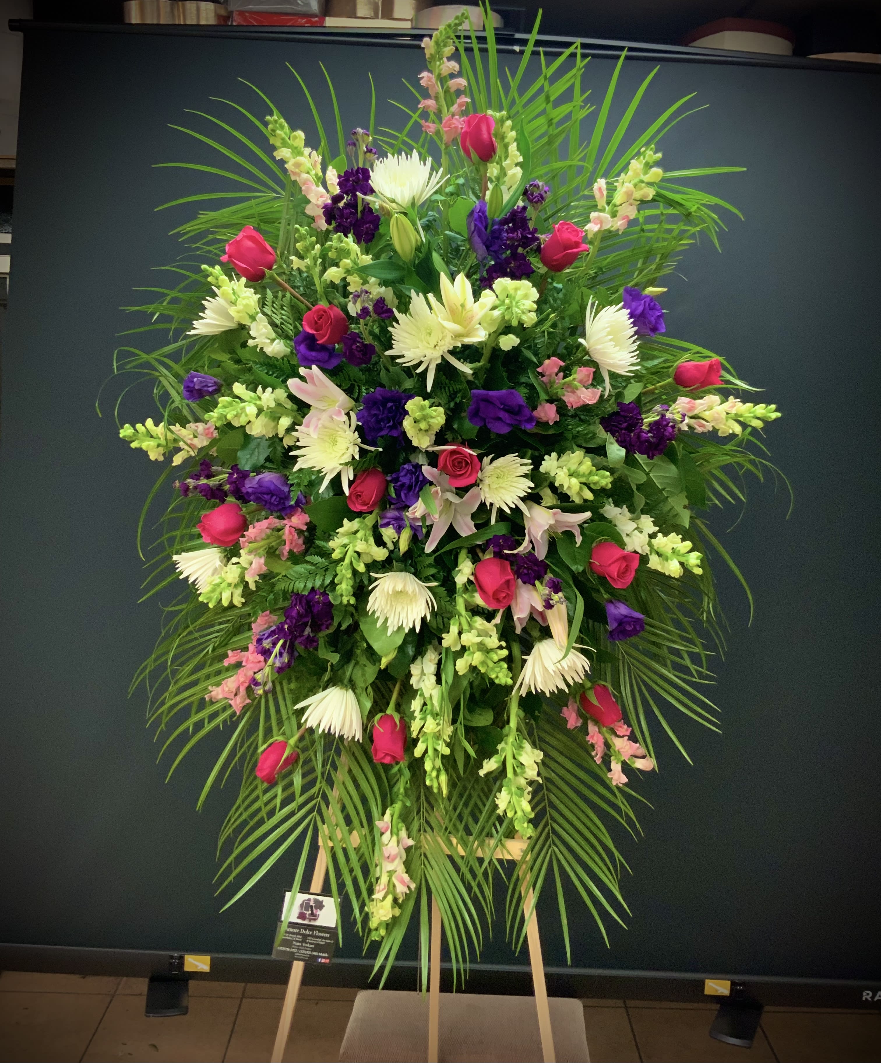 In Loving Memory In Loving Memory - Flowers will come as shown. Some substitution will vary depending on availability and season. A photo will be sent prior to delivery for approval. Arrangement comes on a 6´ easel.