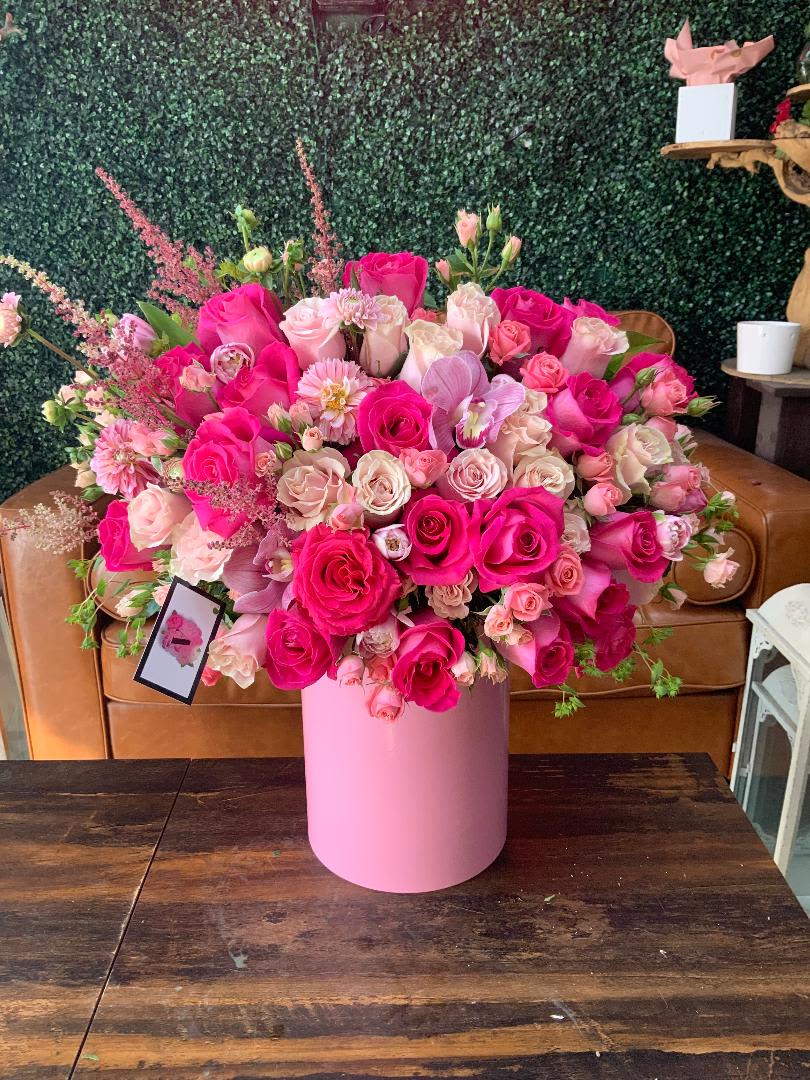 Pretty Pinks Hat Box - Beautiful mix of pink seasonal roses and flowers arranged in a white hat box. Some substitutions might be made depending on availability