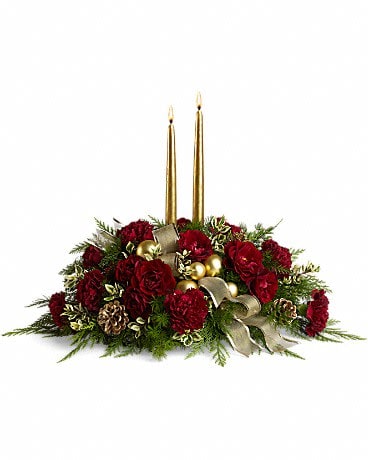 Crimson and Candlelight Crimson and Candlelight - More than a centerpiece, this glorious arrangement is a work of floral art with its magnificent combination of roses, carnations, cedar and fern accented with gold pinecones and ornament balls. Lucky table, lucky guests. The lush arrangement includes dark red spray roses, maroon carnations, green rhamnus, cedar, fern and oregonia accented with gold pinecones, ornament balls and ribbon. Includes two 12" gold candles.