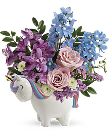 Enchanting Pastels Unicorn Bouquet - Pure enchantment! This sweet ceramic unicorn with hand-painted details can't wait to share this pretty pastel bouquet with your someone special!  This enchanting arrangement features light pink roses, purple alstroemeria, light blue delphinium, white button spray chrysanthemums, pink sinuata statice, and huckleberry.  SUBSTITUTION POLICY – Always deliver the freshest flowers! Please note the bouquet pictured reflects our original design.  If the exact flowers or container in this arrangement are not available, we will create a beautiful bouquet with the freshest available flowers.