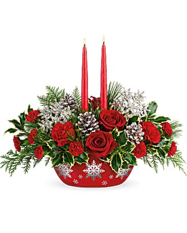 Winter's Eve Centerpiece  - Wish them a glorious winter with this elegant centerpiece of red roses and fresh holly, arranged with glowing tapers in a hand-glazed, oven-to-table ceramic serving dish they'll enjoy for many Christmases to come!  This bouquet featured red roses, red carnations, miniature red carnations, flat cedar, variegated holly, white pine, and two red candles. Delivered in a Winter's Eve Dish.