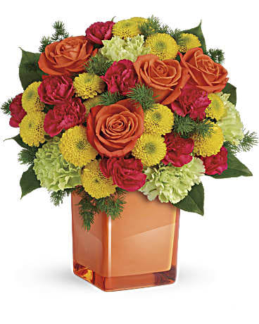 Citrus Smiles Bouquet - They brighten your days with their friendship and love, brighten theirs with these bold and beautiful blooms! Hand-delivered in a stylish glass cube, a gift in and of itself - this spirited mix of roses, carnations and mums is sure to make them smile!  Bold orange roses, green carnations, dark pink miniature carnations, and yellow button spray chrysanthemums are mixed with ming fern and lemon leaf. Delivered in a glass cube.  Approximately 11 1/2&quot; W x 11 3/4&quot; H