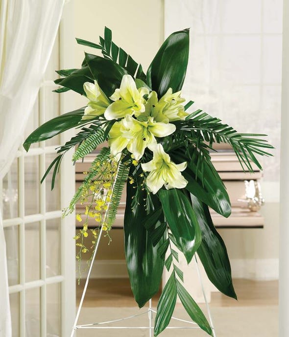 An Exceptional Life Standing Spray An Exceptional Life Standing Spray - Celebrate an exceptional life with this stunning standing spray. Hand arranged with yellow orchids, green Ti leaves and yellow lilies. Delivered on an easel, with a complimentary card. Measures approximately 60"H x 32"W x 12"D.