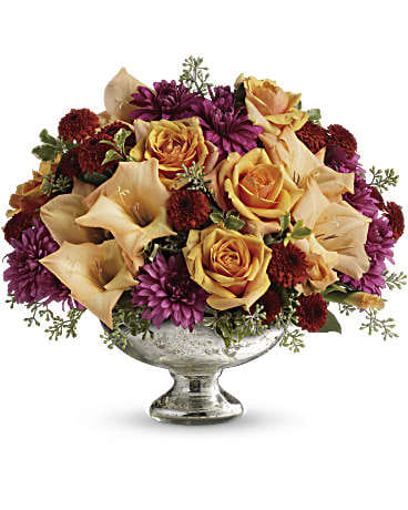Elegant Traditions Centerpiece Elegant Traditions Centerpiece - Fall in love with this elegant arrangement. Orange roses and gladioli are arranged to perfection in our mercury glass bowl. This exquisite bouquet includes orange roses, orange gladioli and lavender cushion spray chrysanthemums accented with assorted greens. Delivered in a mercury glass bowl.