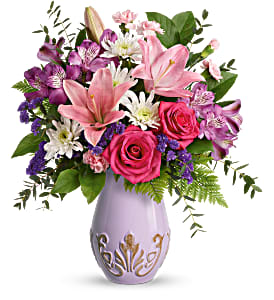 Lavishly Lavender Bouquet - Lavish her in love this Mother's Day with pink roses and lilies, presented to perfection in a fabulous French-inspired vase with elegant embossed details. This feminine bouquet includes hot pink roses, pink asiatic lilies, purple alstroemeria, miniature pink carnations, white cushion spray chrysanthemums, purple sinuata statice, leatherleaf fern, parvifolia eucalyptus, and lemon leaf.