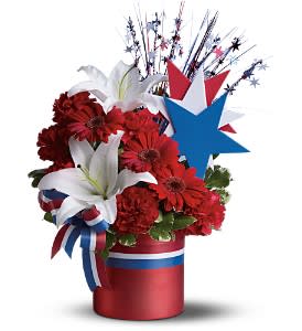 Very Patriotic Bouquet  - Make a patriotic statement with this rousingly arrangement featuring red, white and blue flowers in a shiny red cylinder vase. Great for a Fourth of July party!  The radiant arrangement includes red carnations, white Asiatic lilies and miniature red gerberas accented with variegated pittosporum and Israeli ruscus. Delivered in a bright red ceramic cylinder vase with a satin finish decorated with red, white and blue ribbons and stars