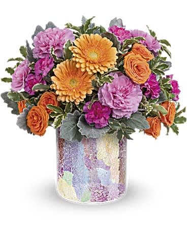 Precious Jewel Bouquet - Joyful roses and gerberas bring happiness wherever they go! Especially when presented in this stunning mosaic glass vase with shimmering iridescent finish.  Orange spray roses, miniature peach gerberas, pink carnations and miniature pink carnations are arranged with dusty miller and pitta negra. Delivered in Teleflora's Radiantly Rosy cylinder. Orientation: All-Around  SUBSTITUTION POLICY – Always deliver the freshest flowers! Please note the bouquet pictured reflects our original design.  If the exact flowers or container in this arrangement are not available, we will create a beautiful bouquet with the freshest available flowers.