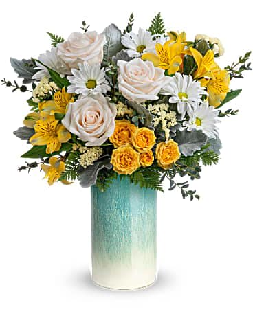 Sunrise Breeze Bouquet - Sunny yellow roses and cloud-white blooms look fresh as can be in this stunning stoneware vase with crackled aqua glaze that sparkles in the sun.  This arrangement includes crème roses, yellow spray roses, white daisy spray chrysanthemums, yellow alstroemeria, crème sinuata statice, parvifolia eucalyptus, dusty miller and leatherleaf fern. Delivered in an Aqua Allure vase.  SUBSTITUTION POLICY – Always deliver the freshest flowers! Please note the bouquet pictured reflects our original design.  If the exact flowers or container in this arrangement are not available, our local florists will create a beautiful bouquet with the freshest available flowers.