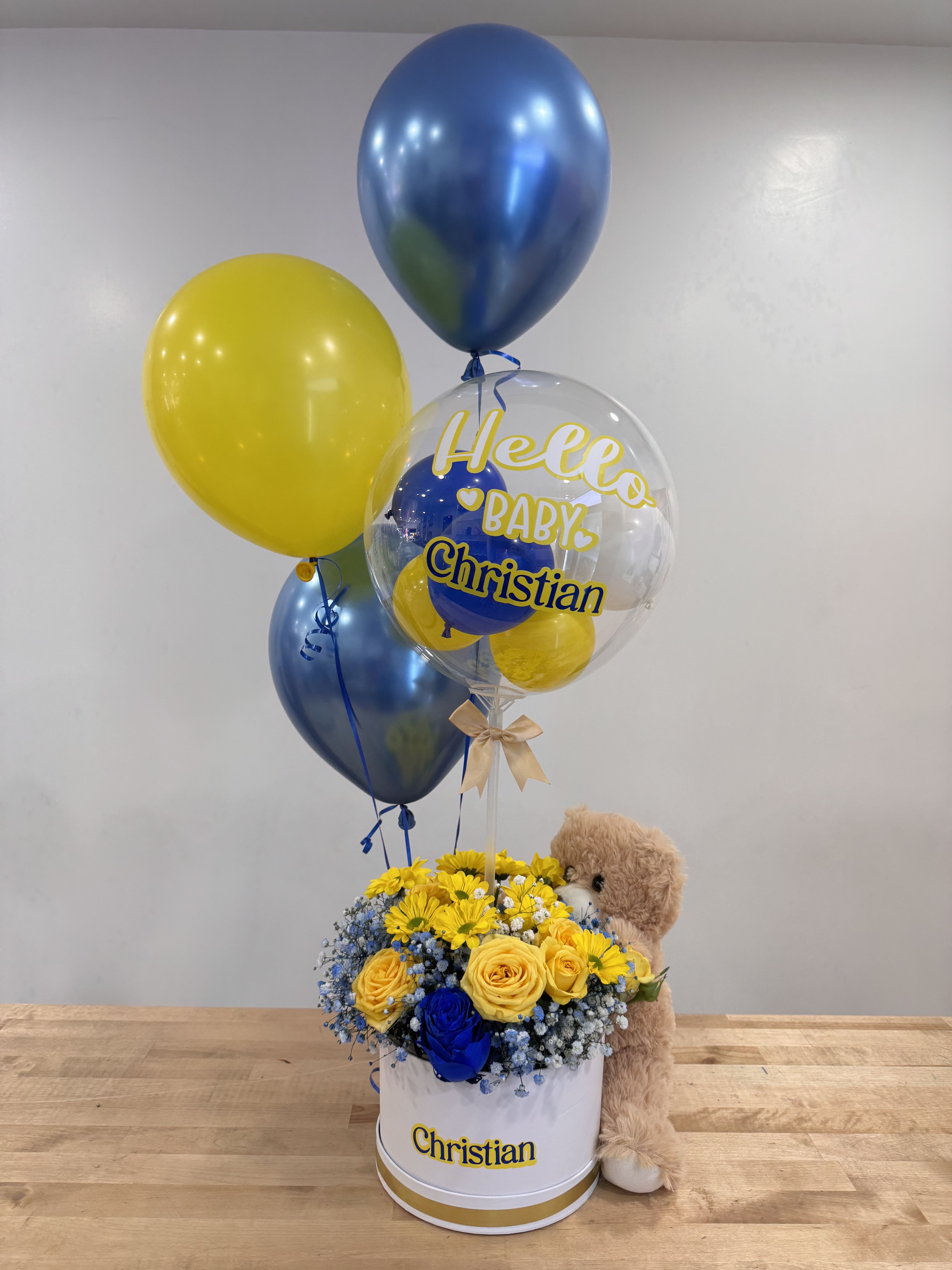 Baby Boy - Beautify the day with this lovely arrangement matching with this teaddy Bear, spread yellow roses, blue baby breath, helium ballons and clear ballon personalized with the name of your requirement!! 