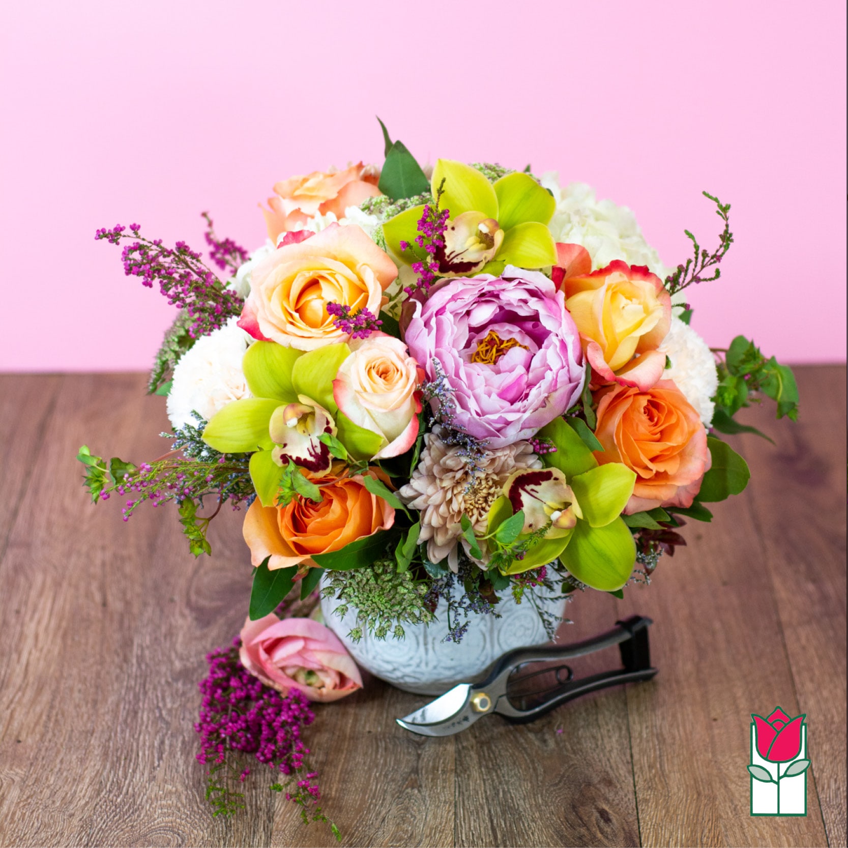 Beretania's Aubrey Bouquet (Seasonal Varieties Vary) - The Beretania Florist Aubrey bouquet is a stunning and elegant floral arrangement that is perfect for any occasion. This compact arrangement is crafted with care using a beautiful combination of seasonally available flowers, including green cymbidium orchids, hydrangea, peach roses, peonies (when in season), and other mixed garden flowers.  The flowers are arranged in a premium ceramic vase, which adds a touch of sophistication and style to this already gorgeous bouquet. Its compact size makes it perfect for any space, from a small desk to a bedside table.  This popular item is now available for delivery in the Honolulu area, making it easy and convenient to brighten someone's day or add a touch of beauty to your own space.  The Beretania Florist Aubrey bouquet is thoughtfully crafted using the best seasonal flowers available, ensuring that every bouquet is unique and special. Order now and let the beauty of this stunning arrangement speak for itself. Whether you're celebrating a special occasion or simply want to brighten someone's day, the Beretania Florist Aubrey bouquet is the perfect choice.